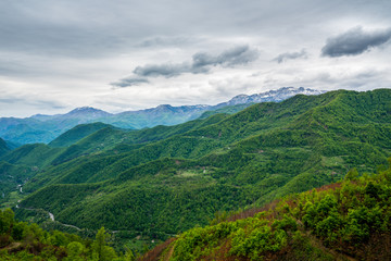 Montenegro, Magical green mountainous nature landscape from above with snow covered mountains at horizon near kolasin
