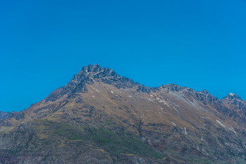 View of the snowy mountain peak against the blue sky, Queenstown, New Zealand. Copy space for text.