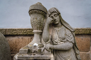 Statue on a grave on the cemetery in Broumov town in Czech Republic