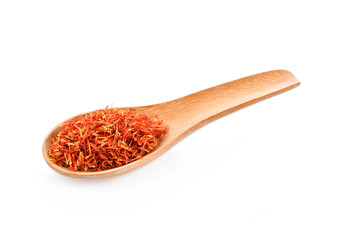 Safflower dried in wood spoon on white background