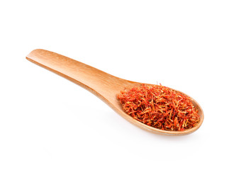 Safflower dried in wood spoon on white background