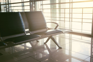 Empty seats in the departure zone. View of airport interoir. Transportation, business travel and vacation theme concept