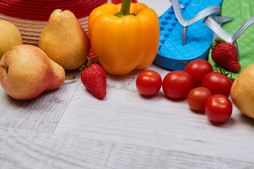 Composition of seasonal vegetables and fruits beside summer accessories. Close up. Food blogging concept