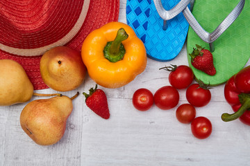 Composition of seasonal vegetables and fruits beside summer accessories. Close up. Food blogging concept