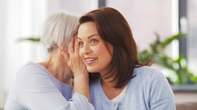 family, generation and people concept - happy smiling senior mother talking to adult daughter at home