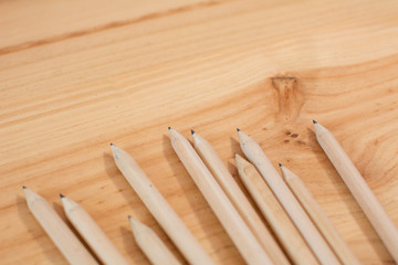 wooden pencils on wooden textured background. School or office material.