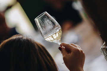 Glass of rose and white wine seen in close hand.