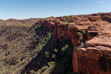 young man enyoing view of the a Canyon and standing on the edge of a cliff, Watarrka National Park, Northern Territory, Australia