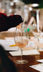 Glass of rose and white wine seen in close hand.