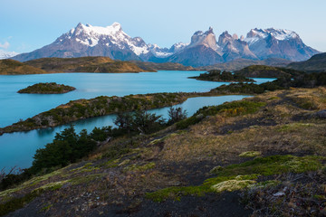 Torres del Paine National Park. Calm lake of Pehoe and snow capped mountains of Cordillera Paine during the early morning. Chile