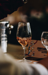 Glass of rose and white wine seen in close hand.