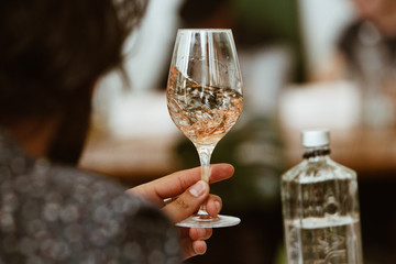 Glass of rose and white wine seen in close hand.