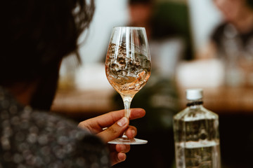 Glass of rose and white wine seen in close hand.