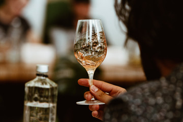 Glass of rose and white wine seen in close hand.