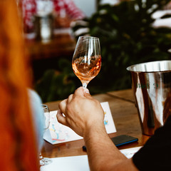 Glass of rose and white wine seen in close hand.