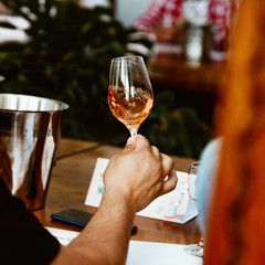 Glass of rose and white wine seen in close hand.