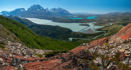 Panorama of the Torres del Paine National Park with rivers, blue lakes, coniferous green forests...