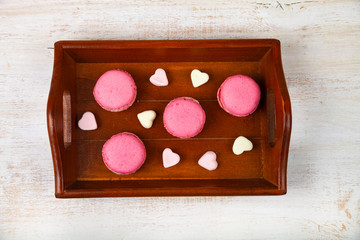 Strawberry macarons and marshmallows on a tray