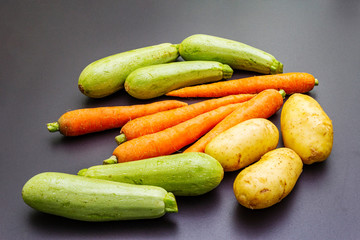 Fresh vegetables cooking black stone background
