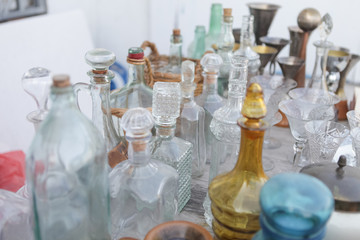 Vintage glass, decorative sculpture, details from flea market. Wooden decor, bottles, glasses, jars, clocks