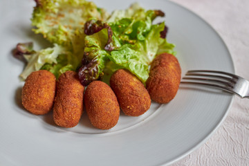 Green salad and chicken croquette in Spanish restaurant