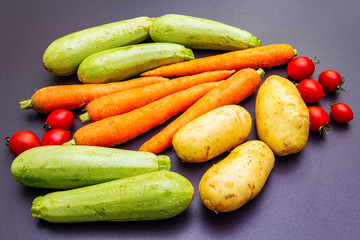 Fresh vegetables cooking black stone background