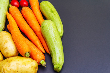 Fresh vegetables cooking black stone background