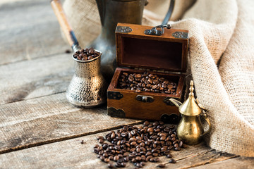 coffee beans and turk on a wooden background