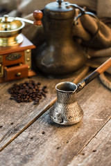 Turkish coffee concept. Copper coffee pot, vintage coffee grinder, coffee beans