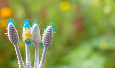 The old toothbrush used expired (damaged) variety of colors on the green background.concept often...