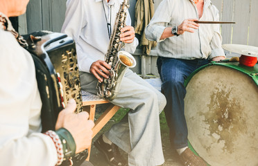 The band of traditional musicians are playing outdoors. Trumpet, drums and accordion. Ukrainian...