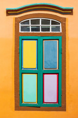Fototapeta na wymiar Colorful facade architecture building, Vibrant color of wooden windows in Little India district, landmark and popular for tourist attractions in Singapore . Southeast Asia Travel concept