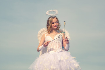 Lovely and cute youth. Girl angel with halo in white angel dress. Valentines day cupid. Cupid in...
