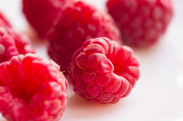 raspberries on a white saucer close up