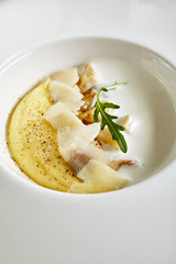 Homemade Italian Cream Polenta, Boiled Cornmeal or Porridge with Porcini Mushrooms and Pecorino Cheese Top View