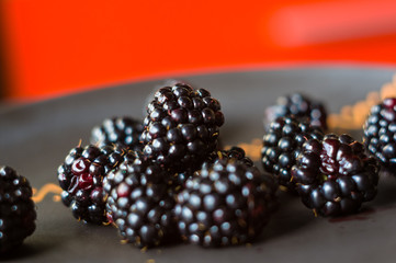large juicy blackberry berries on a ceramic plate