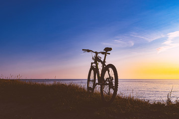 silhouette of a bicycle at sunset. bike without a man.