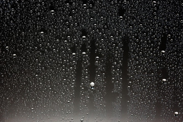 black wet background / raindrops for overlaying on window, concept of autumn weather, background of drops of water rain on glass transparent