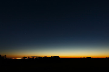 The first stars in the twilight sky at sunset.