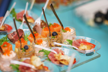 Canapes and light meals, tapas on the table in the restaurant.