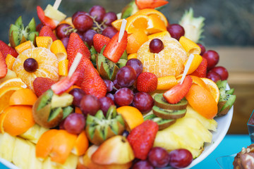 Summer bright fruit plate on the table in the restaurant.