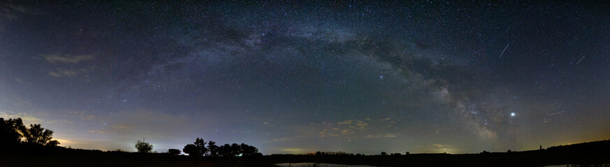 Bright stars in the night sky. Panoramic view of the arch of the Milky Way. Outer space photographed with long exposure.