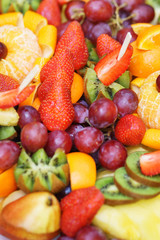 Summer bright fruit plate on the table in the restaurant.