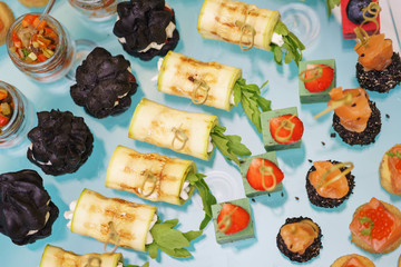 Canapes and light meals, tapas on the table in the restaurant.