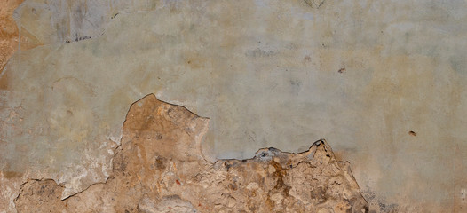 Old Wall With Peel Grey Stucco Texture. Retro Vintage Worn Wall Background. Decayed Cracked Rough Abstract Wall Surface.