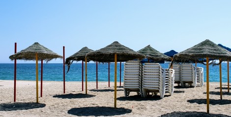 Sun umbrellas and sunbeds in the sand