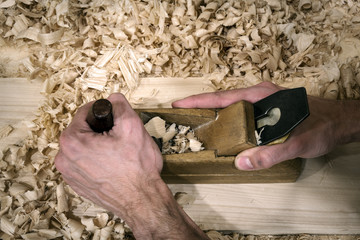 old wooden plane and lots of shavings, .traditional woodworking