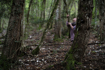 Woman holding a liana in the forest