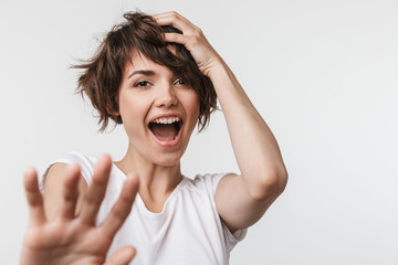 Pretty excited happy woman posing isolated over white wall background laughing.