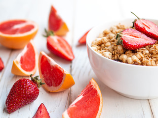 Summer breakfast, oatmeal porridge with strawberries and grapefruit in a bowl - healthy food